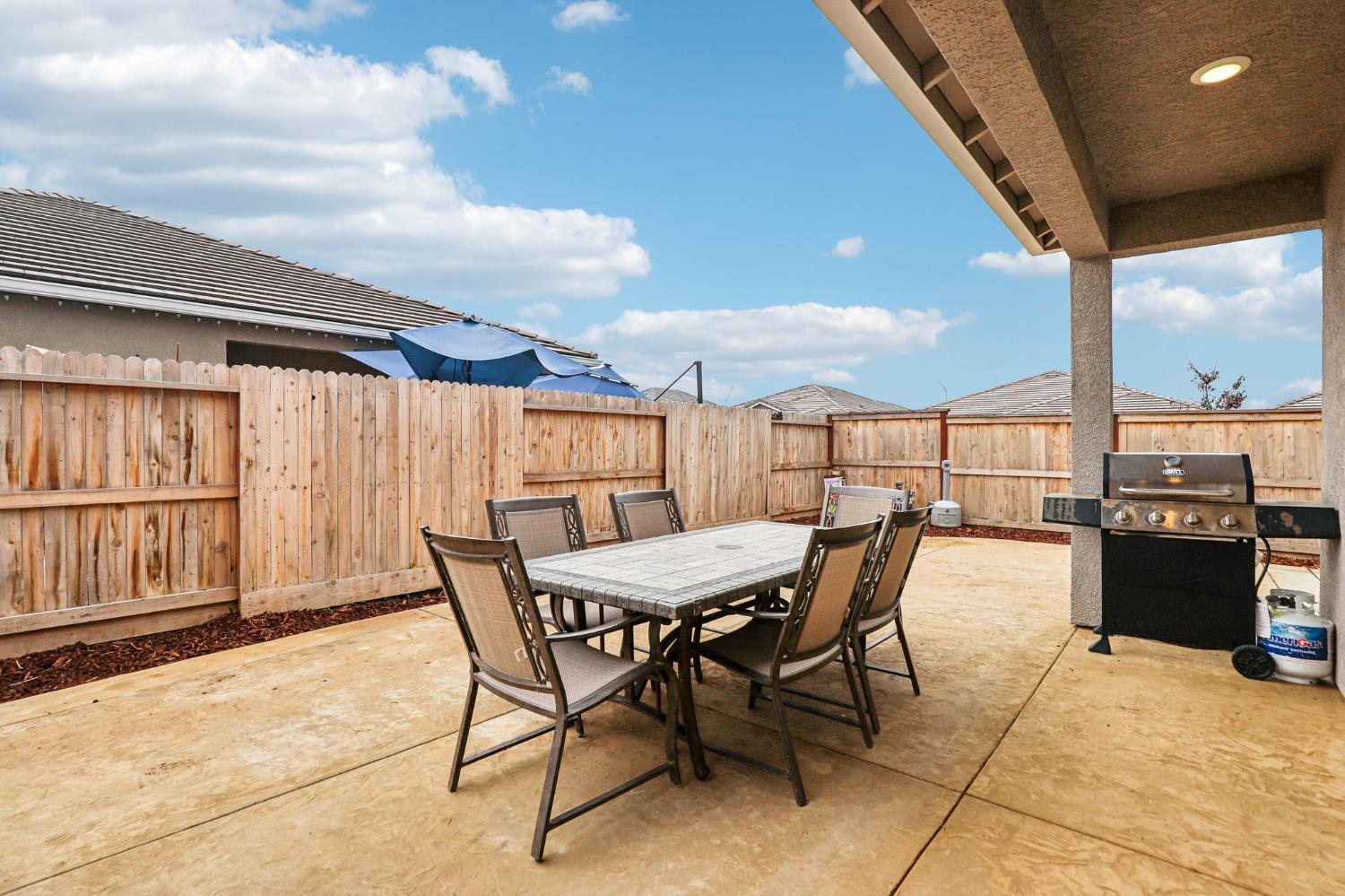 1124 North Palmer Road Galt, CA 95632 - Photo 31 of 41 a view of a patio with a table and chairs