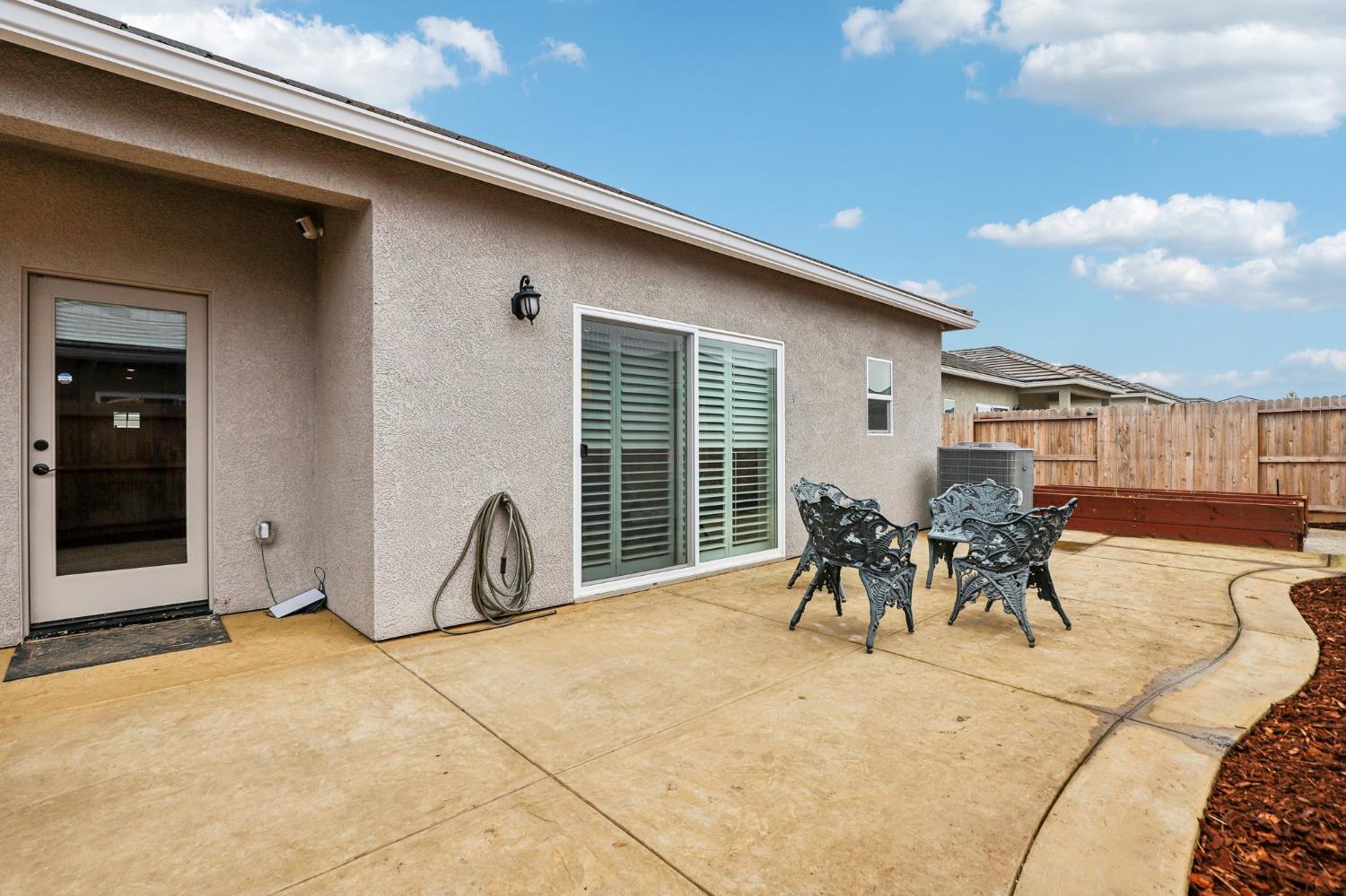 1124 North Palmer Road Galt, CA 95632 - Photo 32 of 41 a patio with table and chairs and potted plants