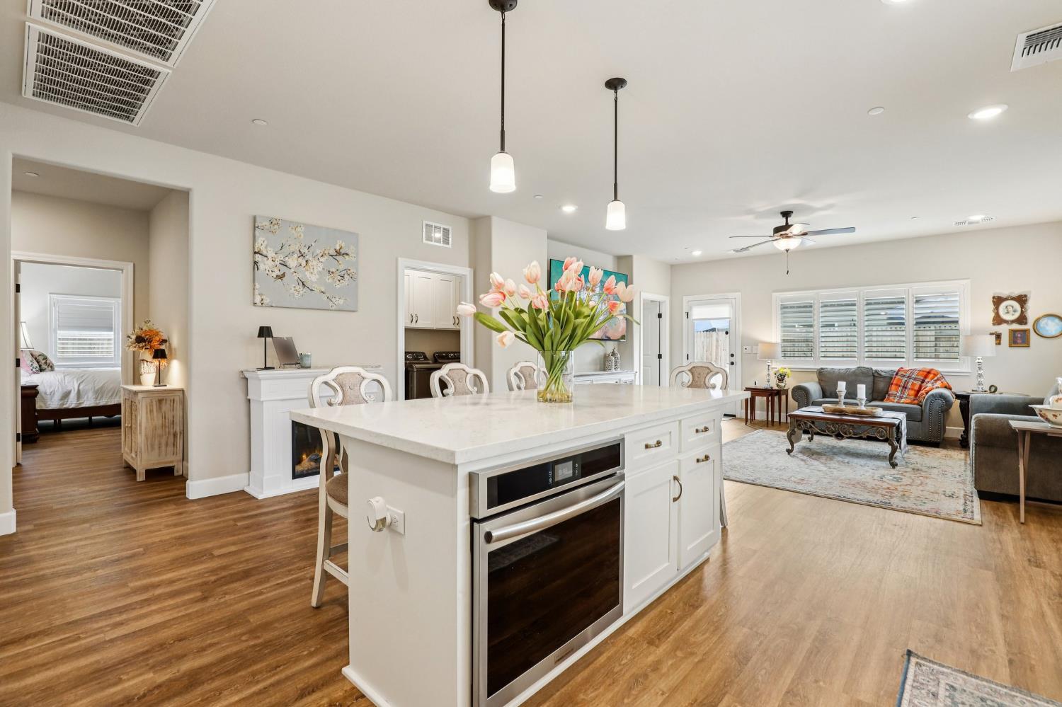1124 North Palmer Road Galt, CA 95632 - Photo 9 of 41 a view of living room kitchen with furniture and wooden floor