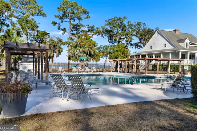 a view of swimming pool with a patio and a yard
