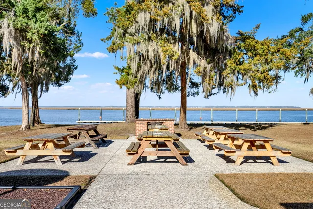 a view of a swimming pool with lawn chairs under an umbrella