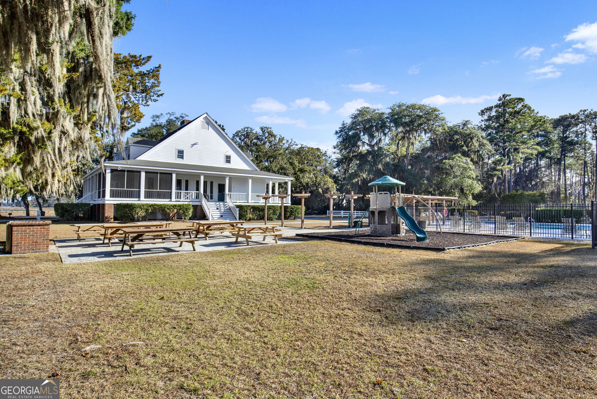 Lot 138 Sapelo Circle Townsend, GA 31331 - Photo 23 of 29 a view of a swimming pool with lawn chairs under an umbrella