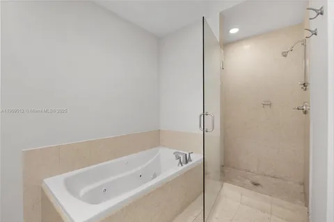a bathroom with a tub shower and vanity