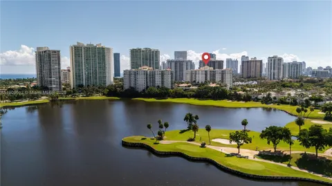 a view of a city with tall trees