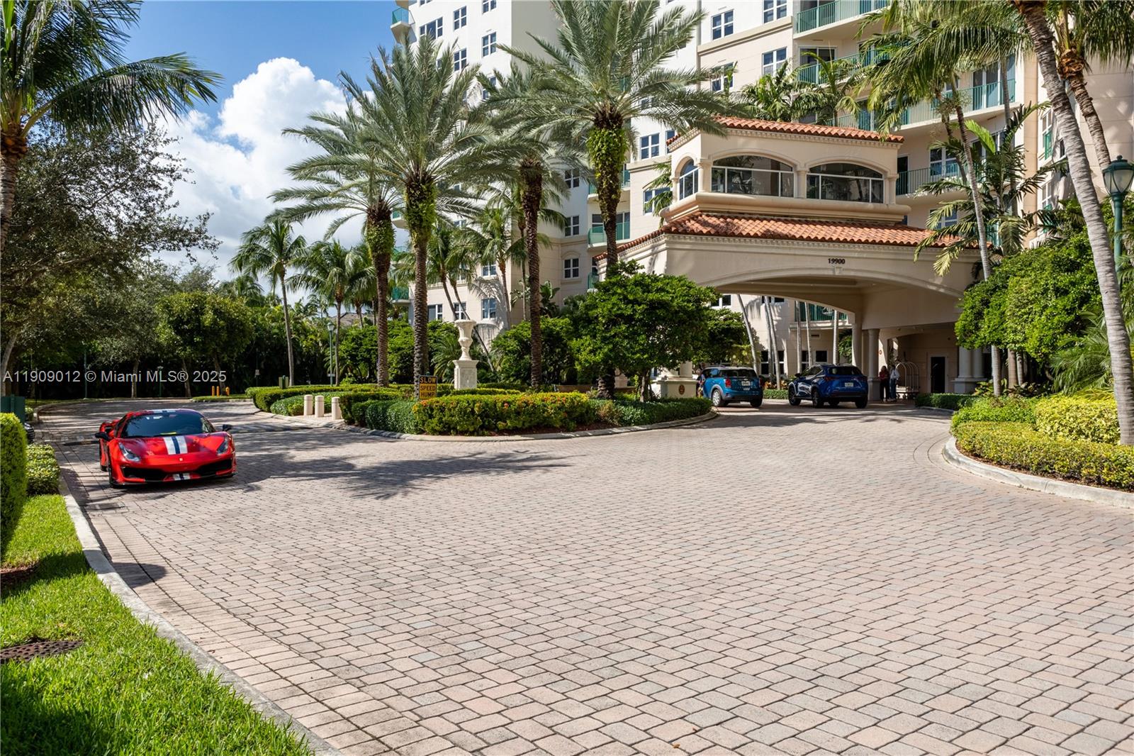 19900 East Country Club Drive, Unit PH18 Aventura, FL 33180 - Photo 25 of 45 a front view of a house with a yard and potted plants