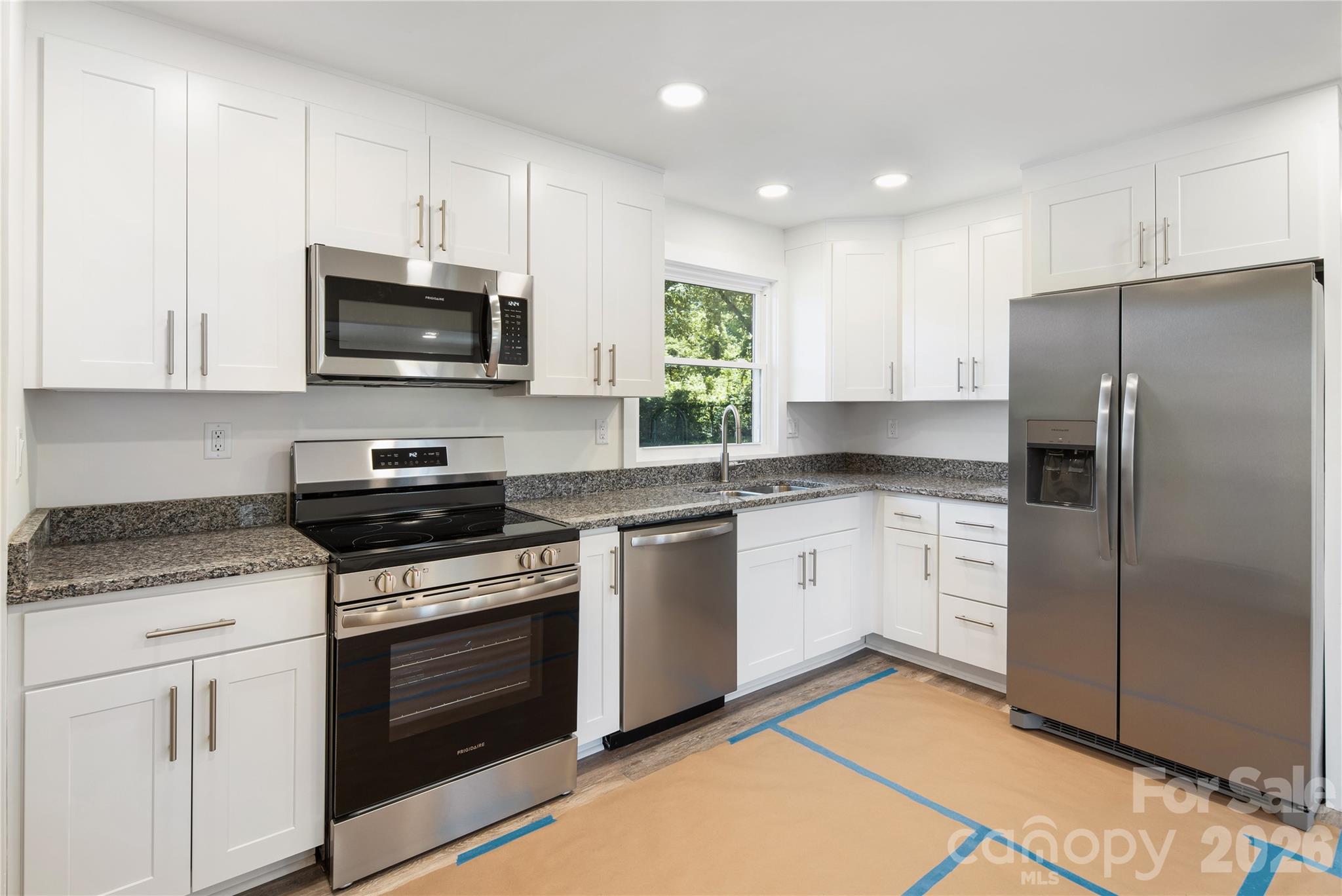 287 Duncan Road Flat Rock, NC 28731 - Photo 4 of 13 a kitchen with cabinets stainless steel appliances and wooden floor