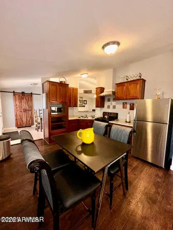 a view of a dining room with furniture and a rug
