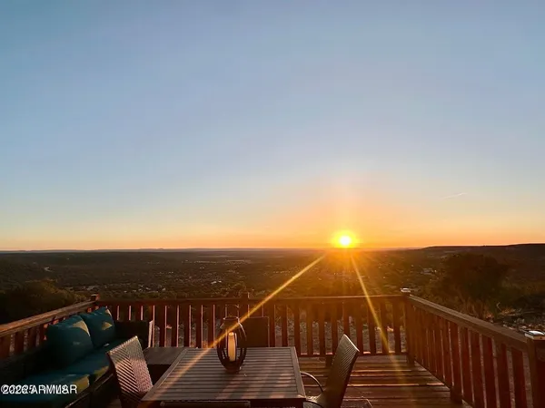 a view of roof deck with mountain view and wooden floor