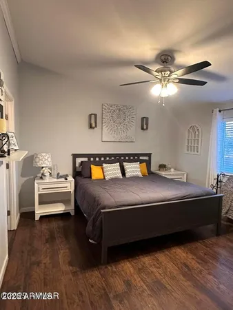 a spacious bedroom with a bed and a chandelier