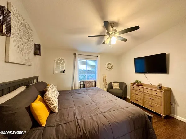 a bedroom with a bed and a flat screen tv