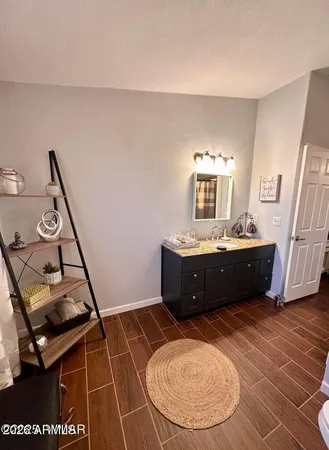 a room with a sink a window and gym equipment