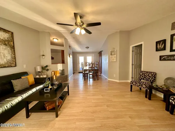 a living room with furniture and wooden floor