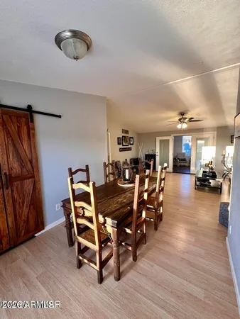 a dining room with furniture and wooden floor