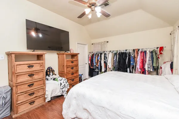 a bedroom with a bed and a flat screen tv
