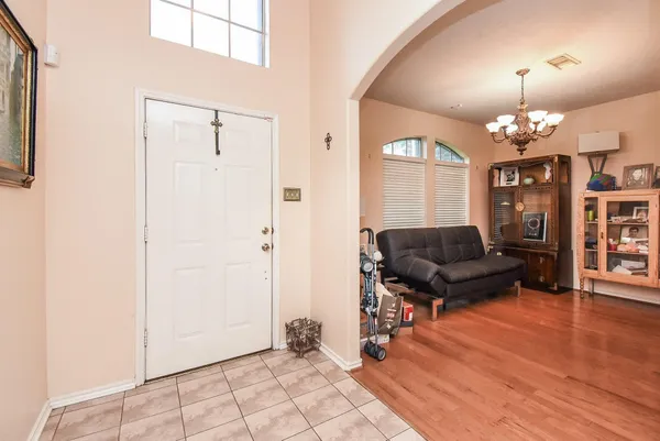 a living room with furniture and a chandelier