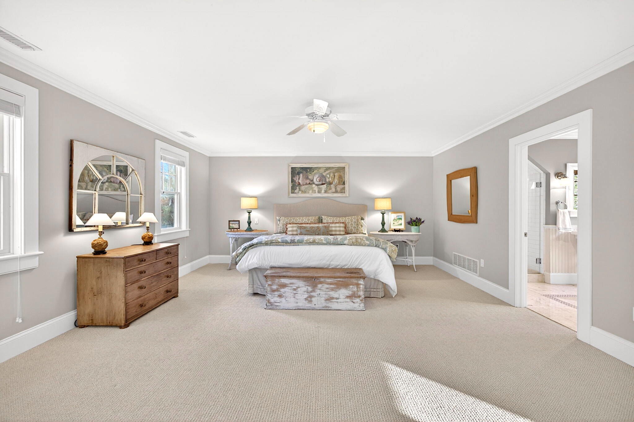 205 Little River Road Cotuit, MA 02635 - Photo 24 of 60 a spacious bedroom with a large bed and a chandelier