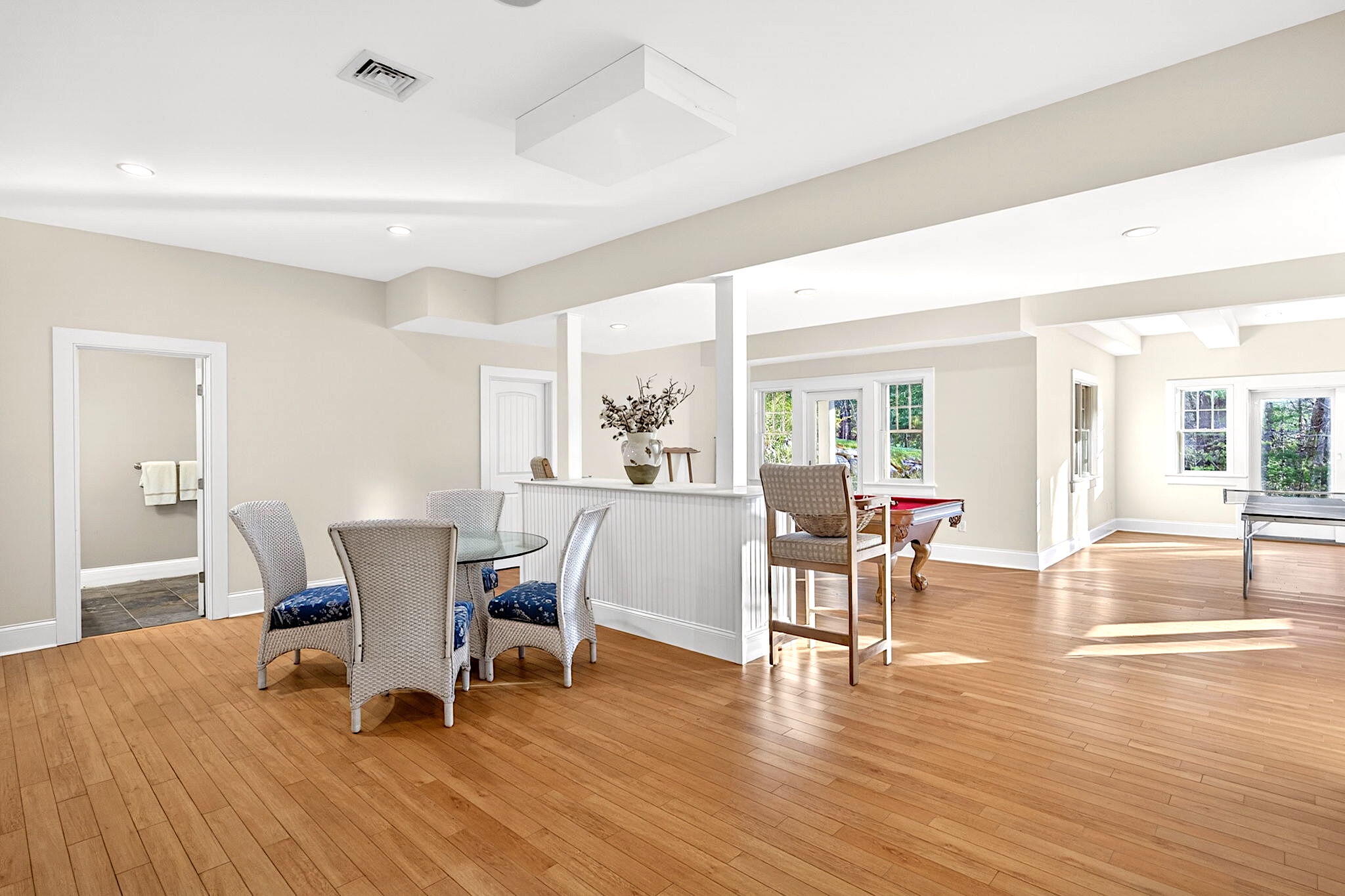 205 Little River Road Cotuit, MA 02635 - Photo 33 of 60 a dining room with wooden floor and large windows