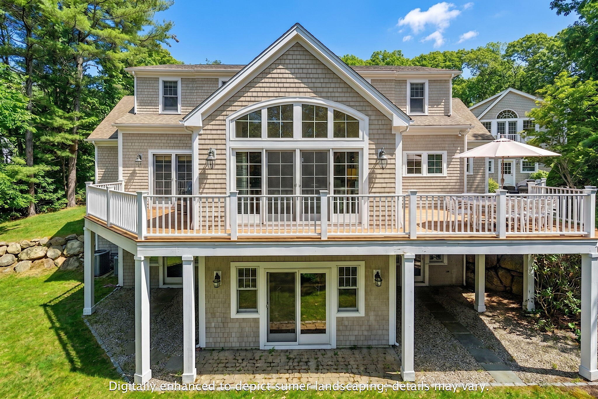 205 Little River Road Cotuit, MA 02635 - Photo 4 of 60 a front view of a house with glass windows