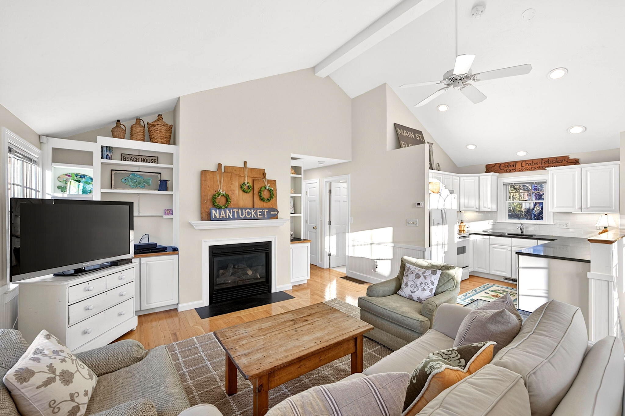 205 Little River Road Cotuit, MA 02635 - Photo 52 of 60 a living room with furniture a flat screen tv and a fireplace