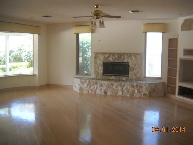 8601 Surrey Lane Boca Raton, FL 33496 - Photo 5 of 18 an empty room with windows and fireplace