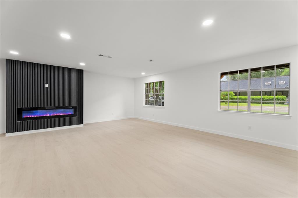 110 Hackberry Street Lancaster, TX 75146 - Photo 10 of 32 Spacious room featuring light wood-finish flooring, recessed lighting, and white walls