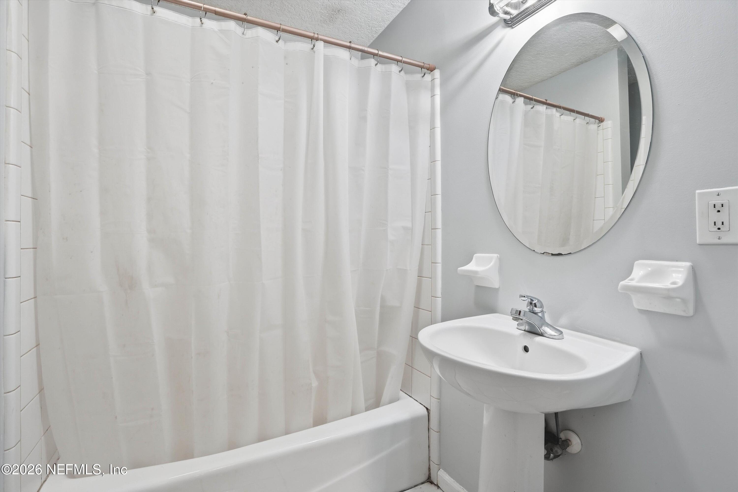 1736 Lakewood Road Jacksonville, FL 32207 - Photo 12 of 31 a bathroom with a sink a mirror and a toilet