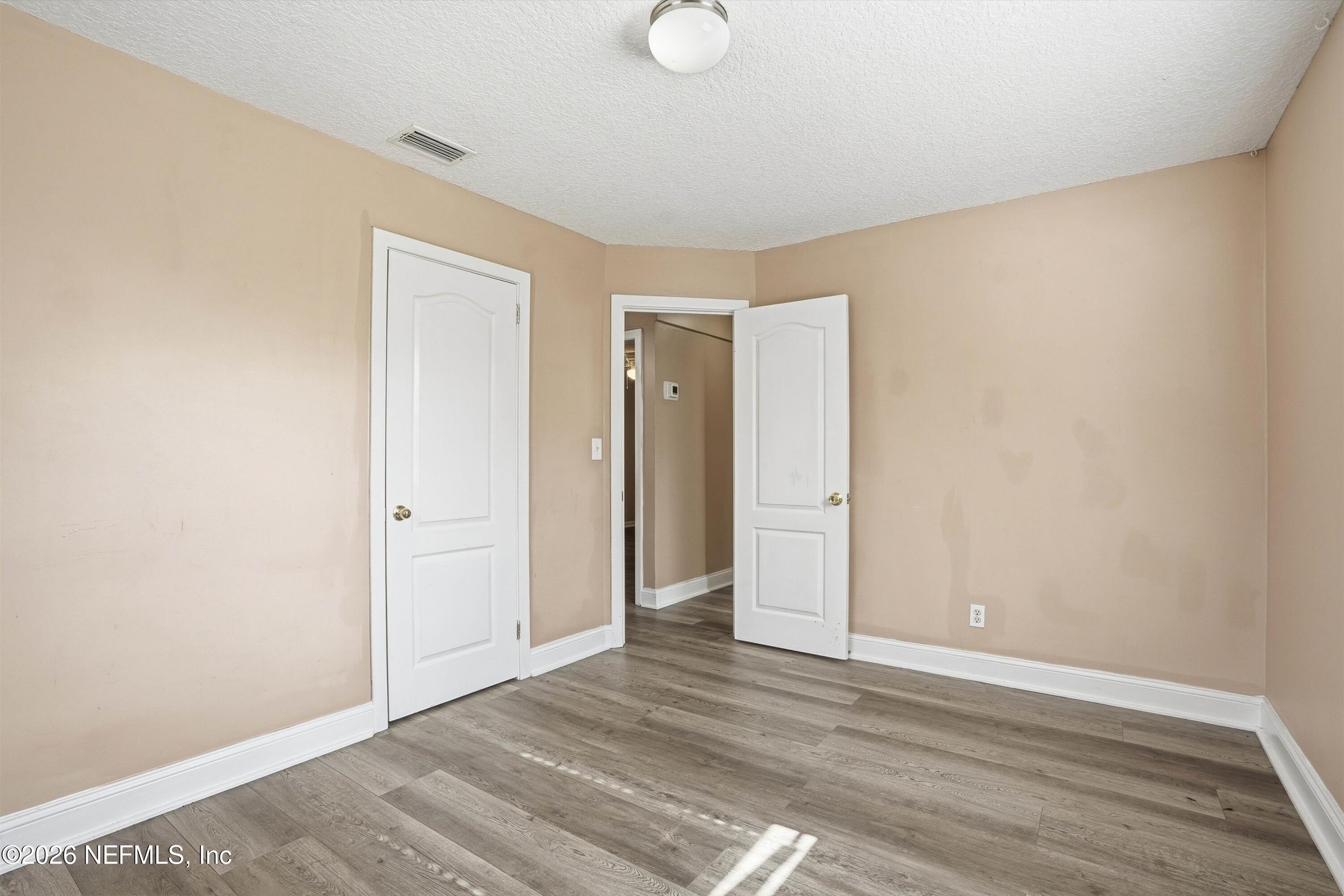 1736 Lakewood Road Jacksonville, FL 32207 - Photo 17 of 31 a view of an empty room and wooden floor