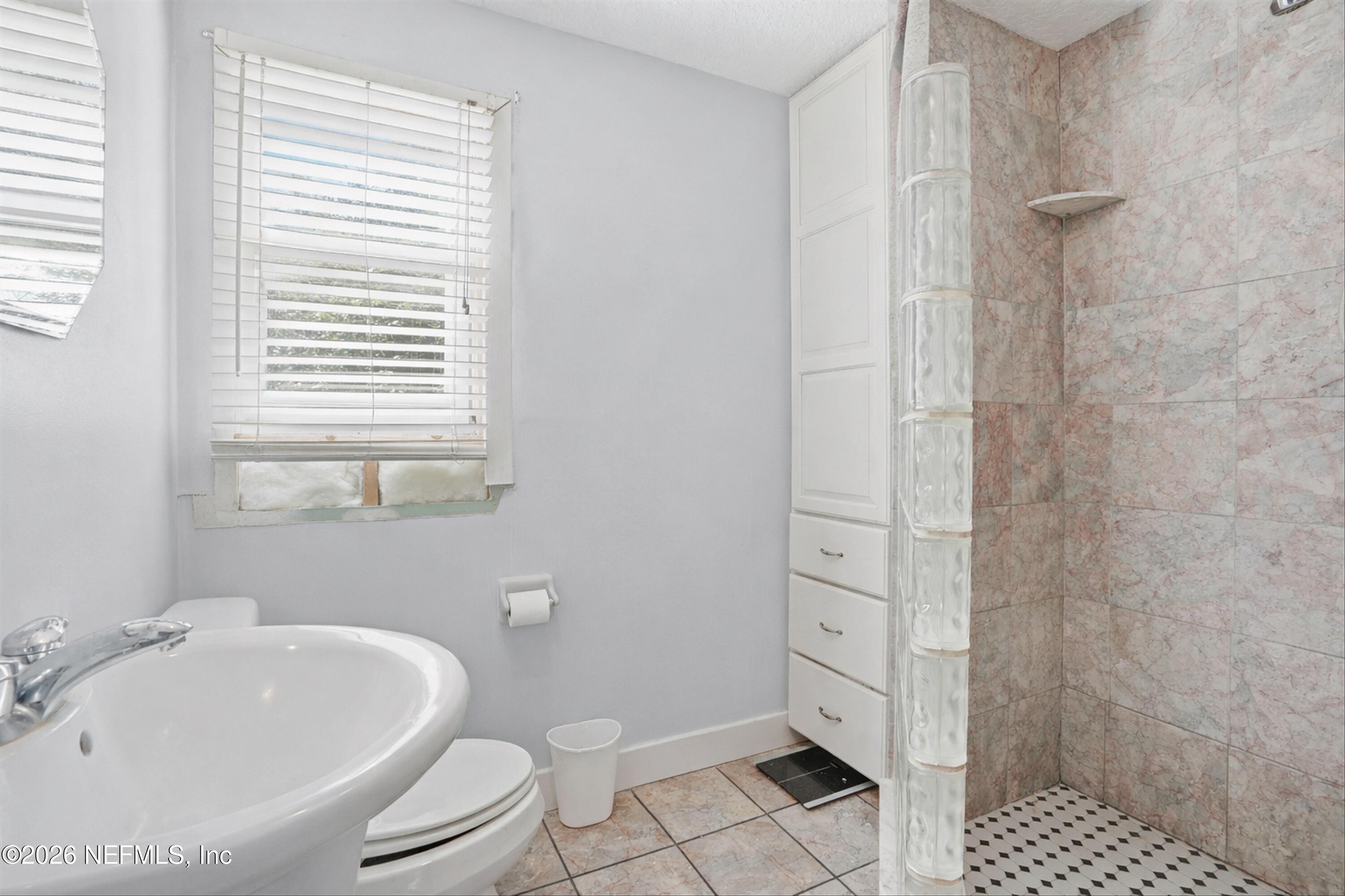 1736 Lakewood Road Jacksonville, FL 32207 - Photo 22 of 31 a bathroom with a bathtub shower sink mirror and toilet