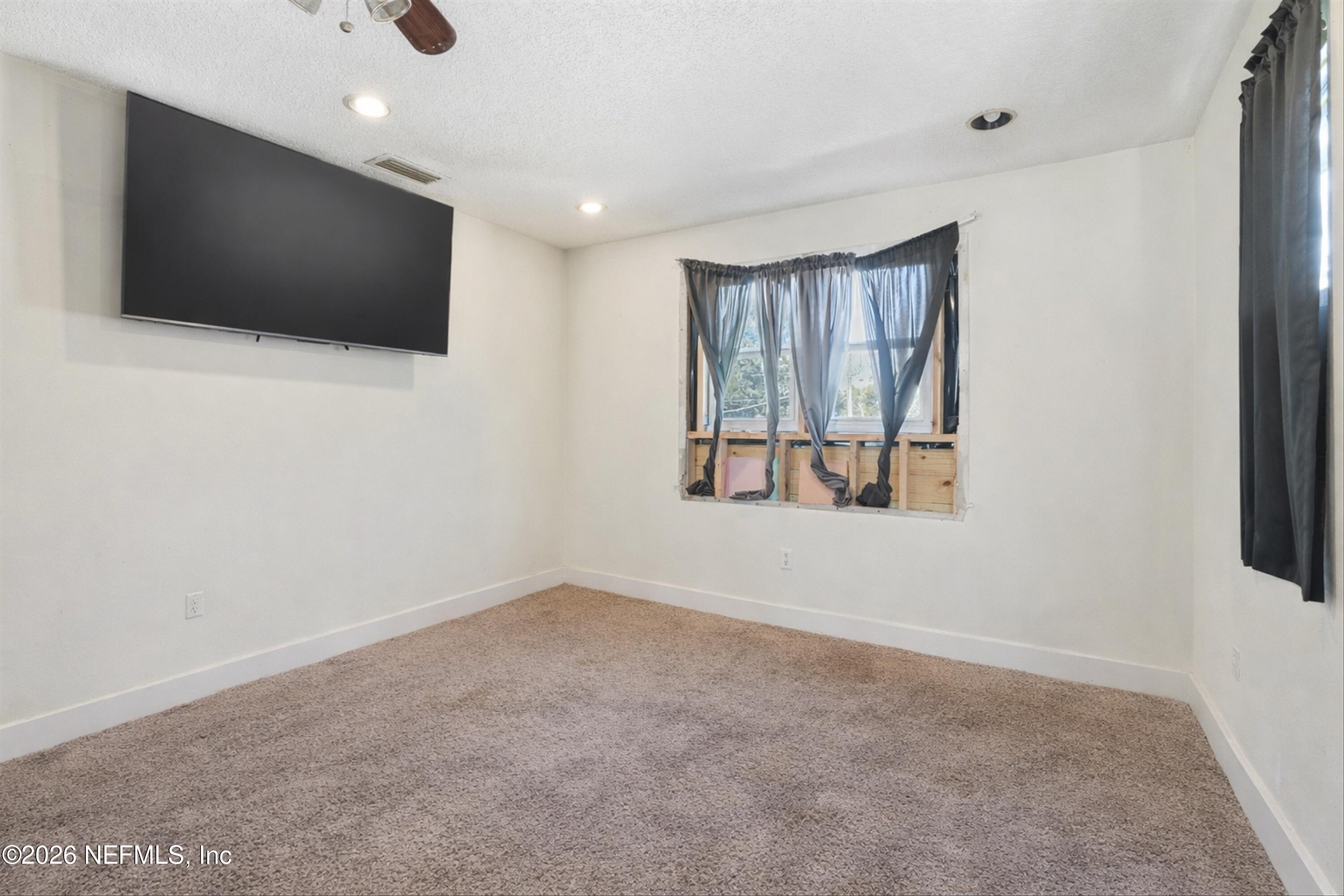 1736 Lakewood Road Jacksonville, FL 32207 - Photo 24 of 31 a view of a livingroom with a flat screen tv