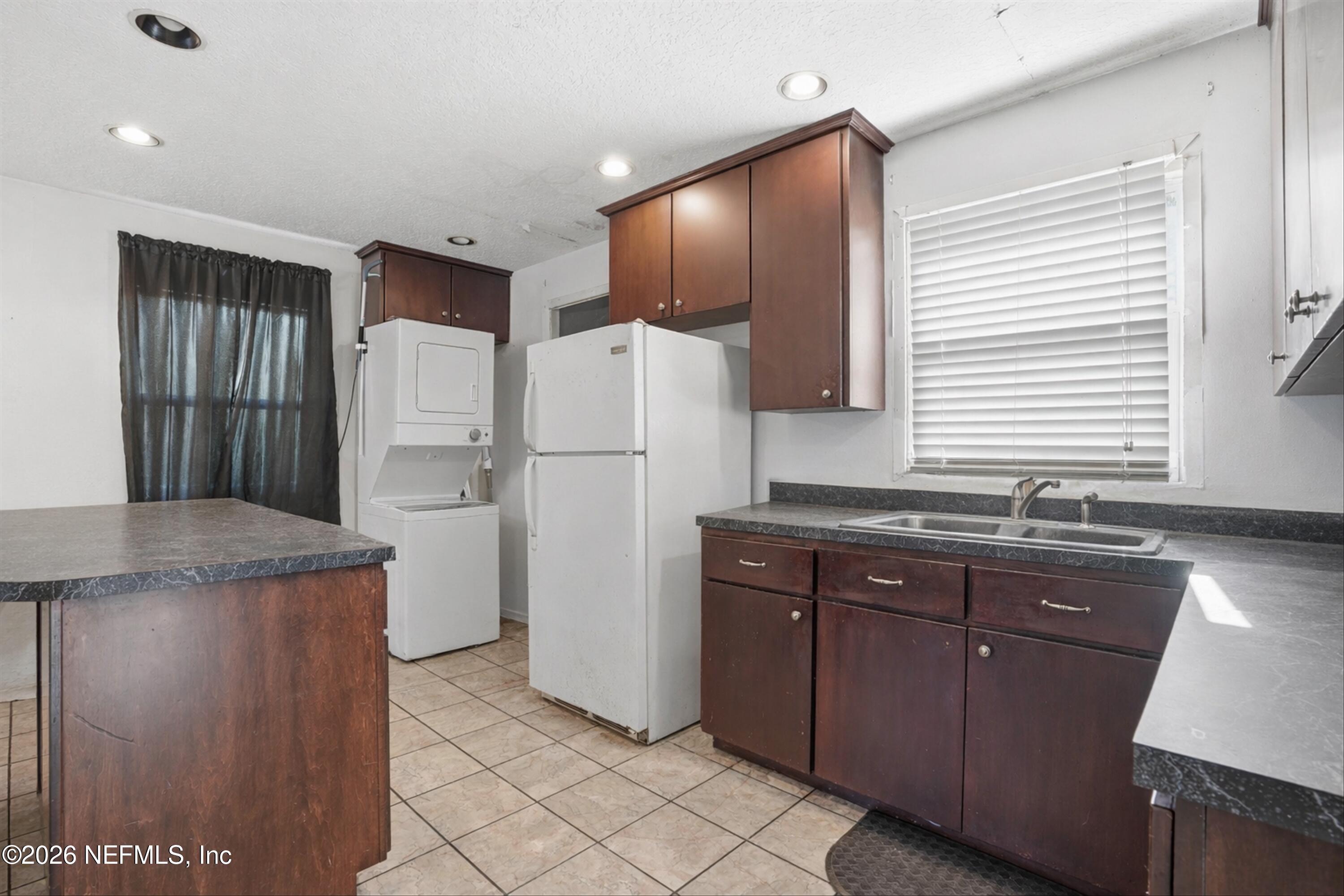 1736 Lakewood Road Jacksonville, FL 32207 - Photo 25 of 31 a kitchen with a refrigerator a sink and cabinets