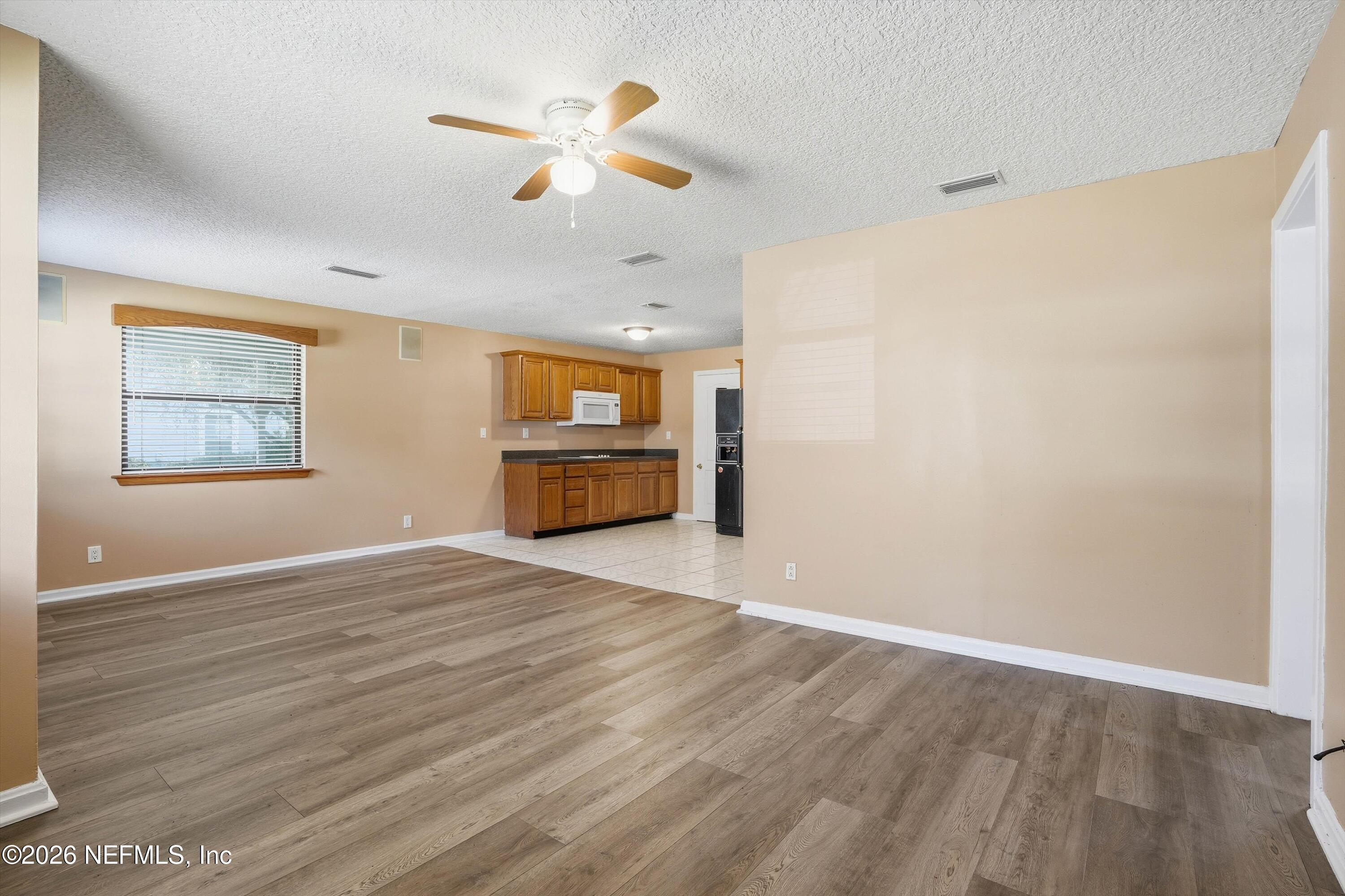 1736 Lakewood Road Jacksonville, FL 32207 - Photo 6 of 31 wooden floor in an empty room with a window