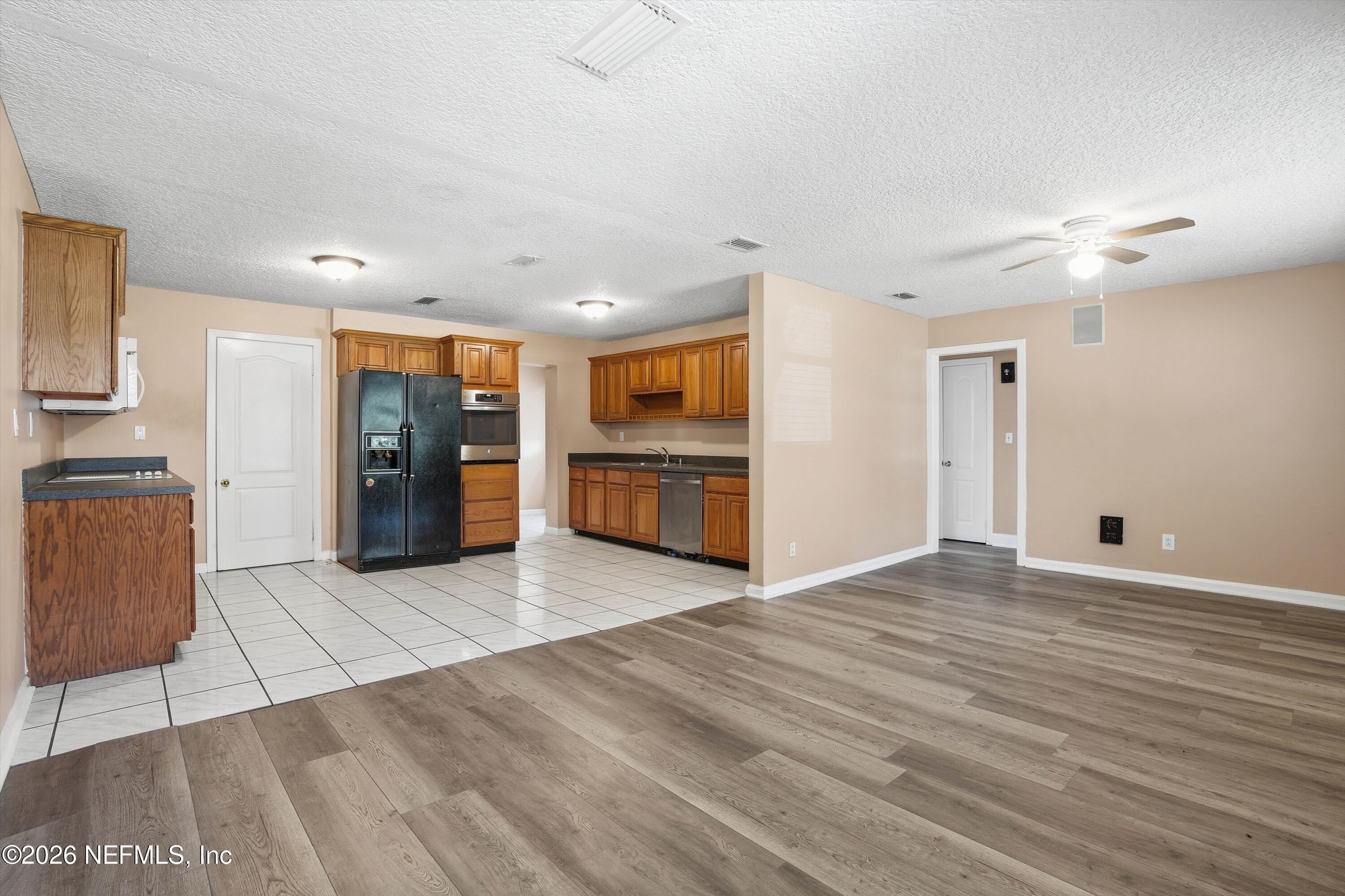 1736 Lakewood Road Jacksonville, FL 32207 - Photo 9 of 31 a view of an empty room with a kitchen