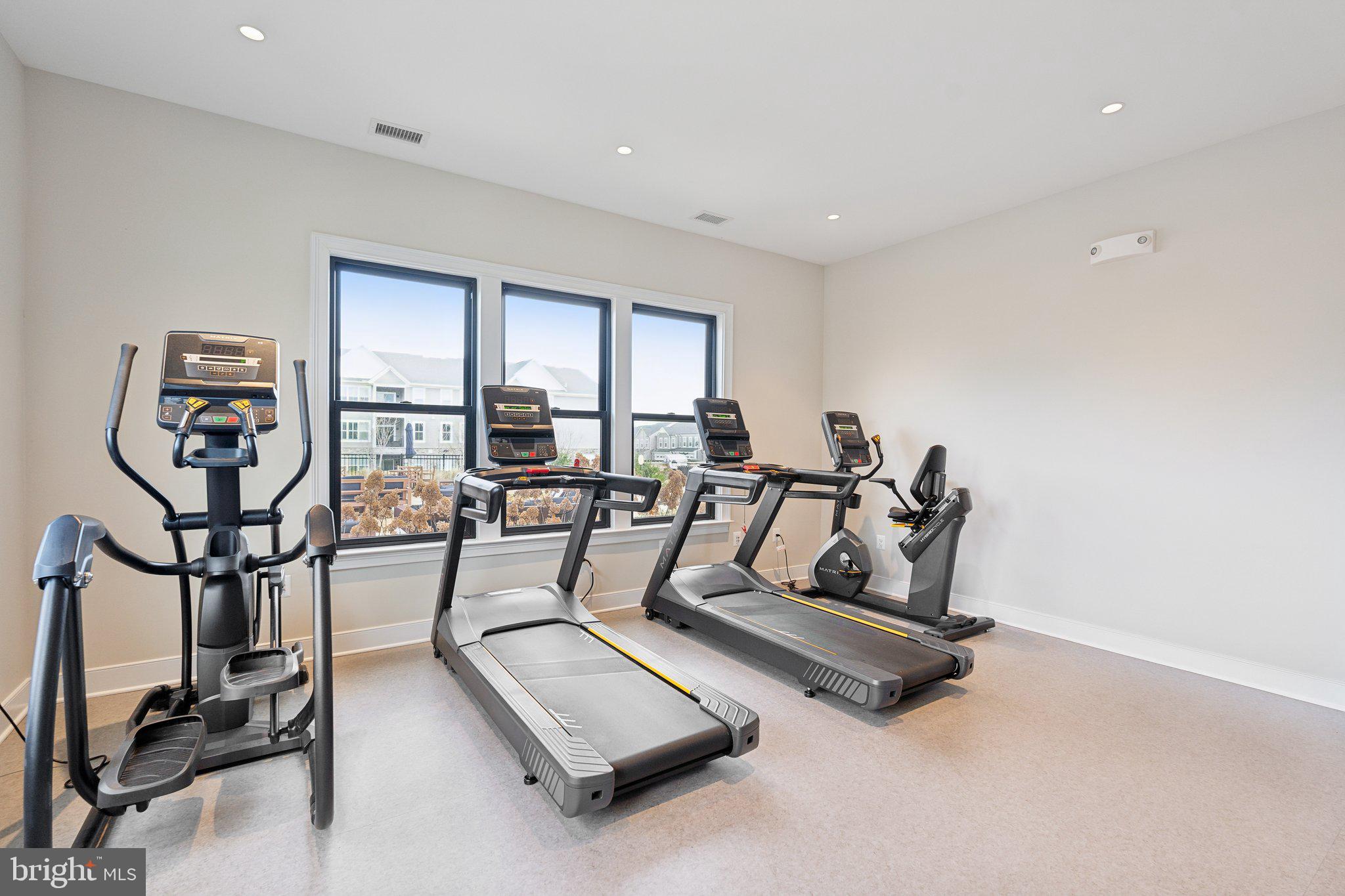 76 Valerian Loop, Unit 2 Stafford, VA 22554 - Photo 19 of 43 a living room with furniture gym equipment and a large window