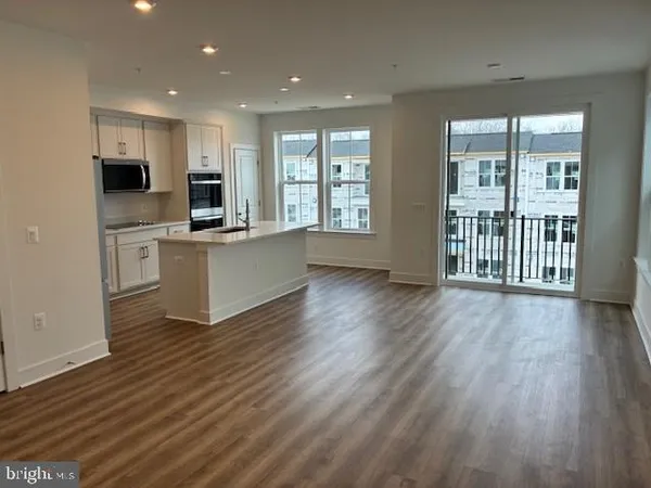 a view of kitchen with sink and wooden floor