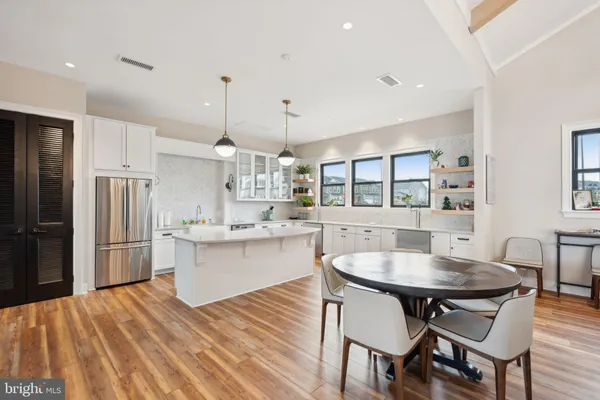 a kitchen with stainless steel appliances granite countertop a sink stove and wooden floor