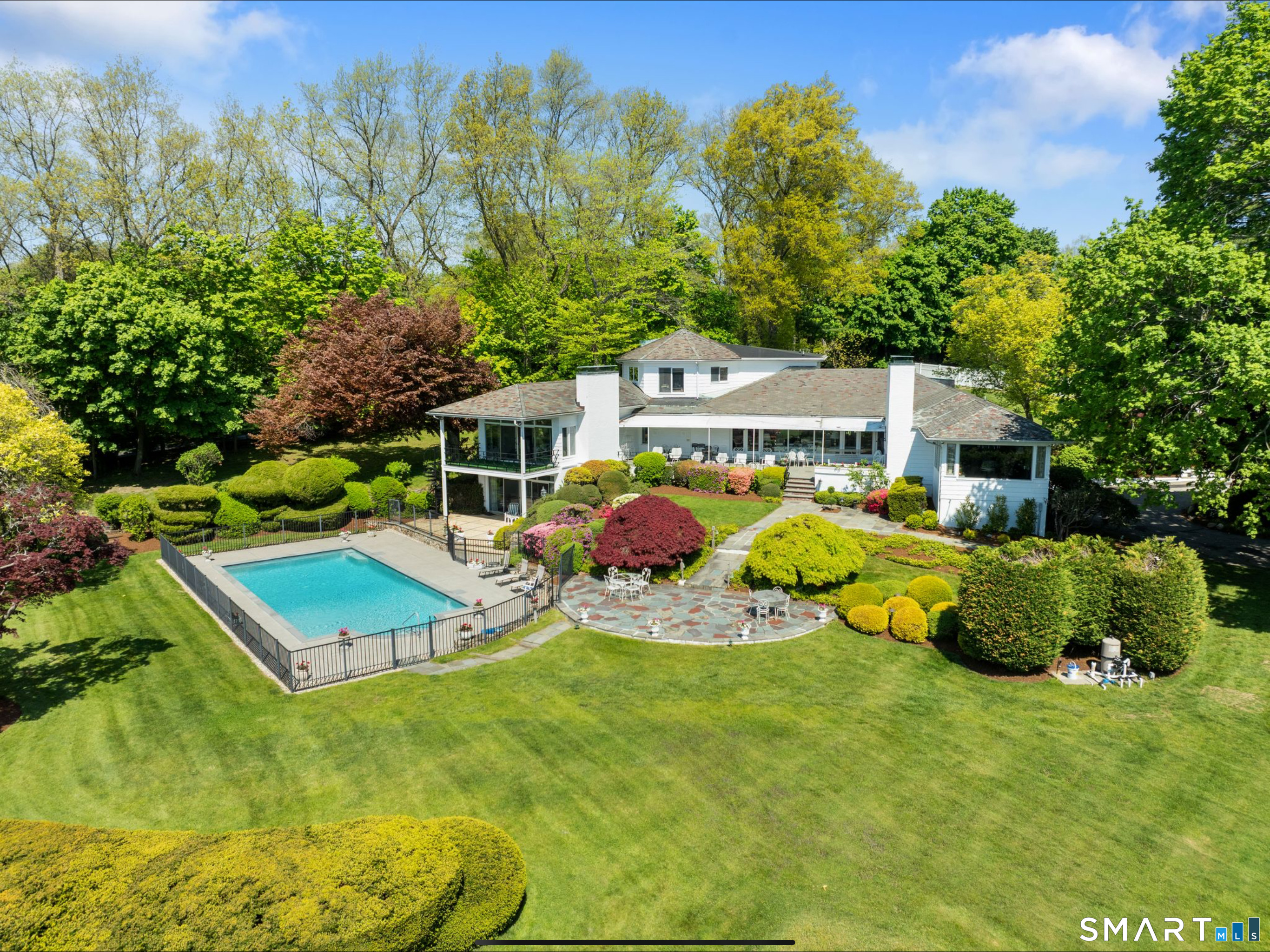 7 Sasqua Road Norwalk, CT 06855 - Photo 33 of 40 a view of a house with a backyard space and sitting area