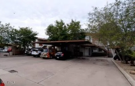 a view of yard from deck with patio
