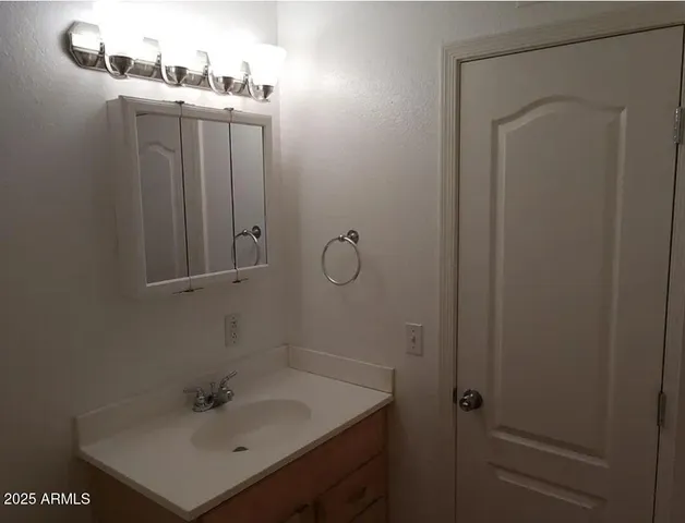 a kitchen with granite countertop a sink stainless steel appliances and cabinets