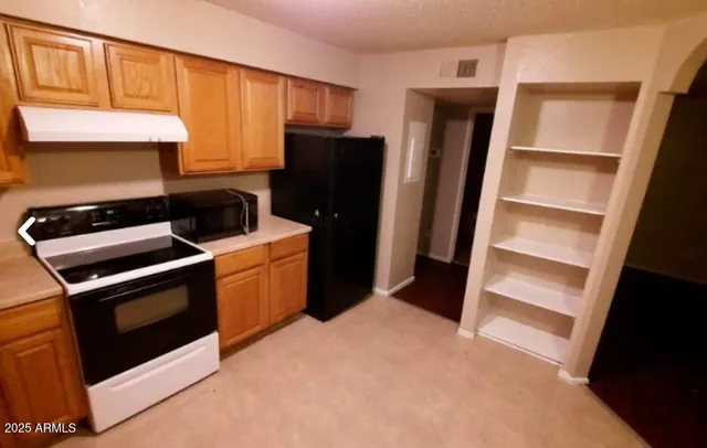 a kitchen with stainless steel appliances granite countertop a sink and cabinets