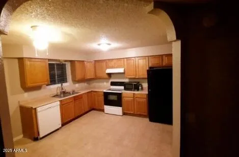 a kitchen with a refrigerator and a sink