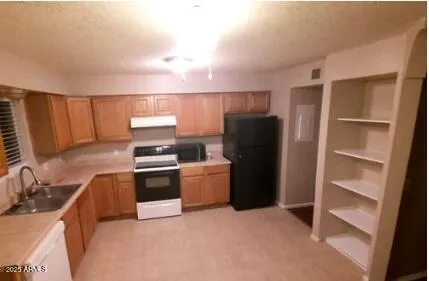 a bathroom with a granite countertop toilet and a sink