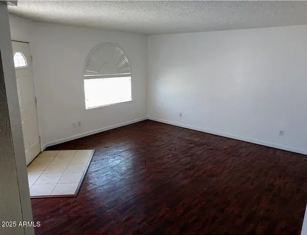 an empty room with wooden floor