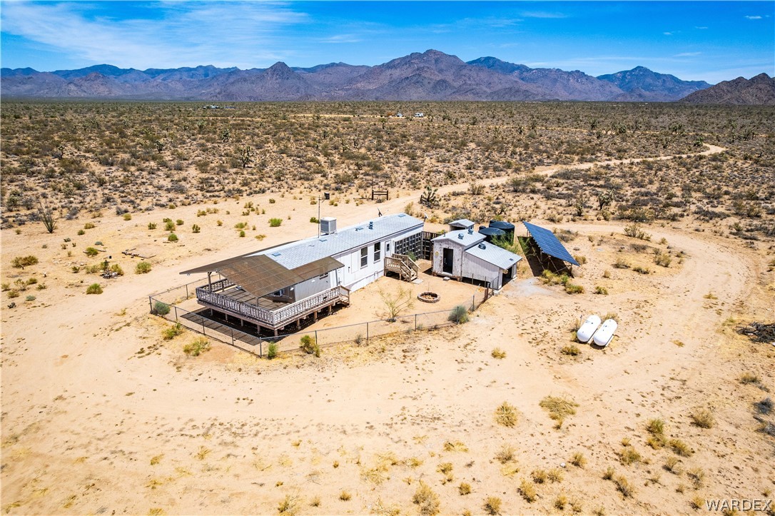 16435 South Wyatt Earp Road Yucca, AZ 86438 - Photo 40 of 57 Expansive desert property featuring a single-story residence with a covered porch and deck