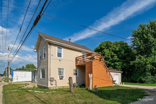 529 West Lincoln Avenue, Unit B Hinckley, IL 60520 - Photo 2 of 9 a view of a house with backyard and a tree