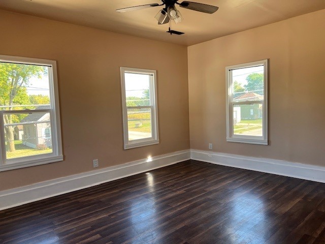 529 West Lincoln Avenue, Unit B Hinckley, IL 60520 - Photo 4 of 9 a view of an empty room with wooden floor and a window