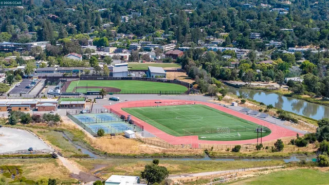a view of a swimming pool with a yard and outdoor seating