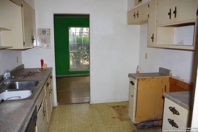 a bathroom with a granite countertop sink a mirror and shower