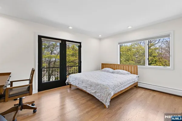 a bedroom with a large bed and a large window