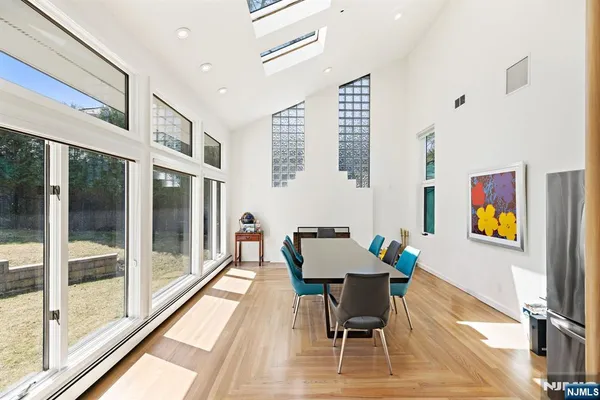 a dining room with furniture and a floor to ceiling window