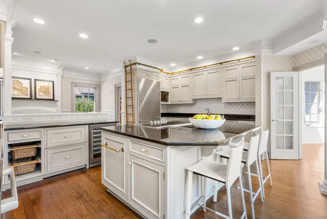 a kitchen with a sink cabinets and wooden floor